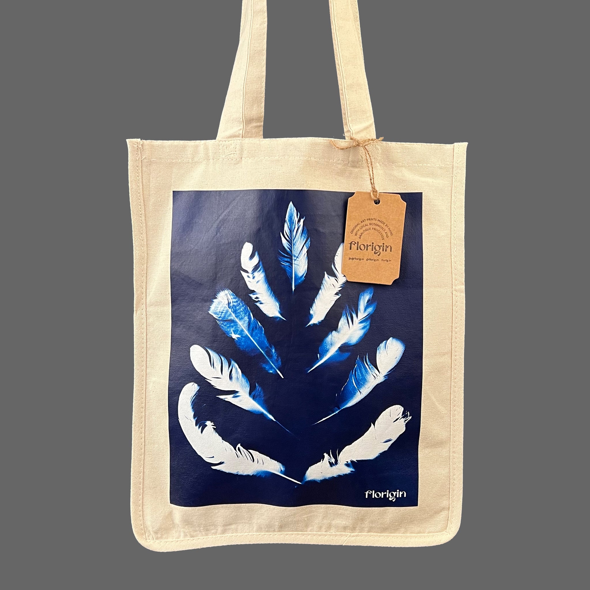 Canvas Tote Shopper with blue image of feathers in a pinocle design sold in the florig.in store